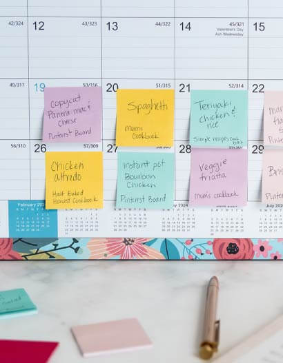 A monthly calendar that has sticky notes on each day