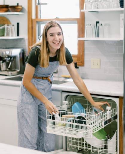 Tasha loading her dishwasher