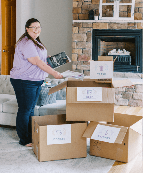 Laura sorting clutter into labeled boxes