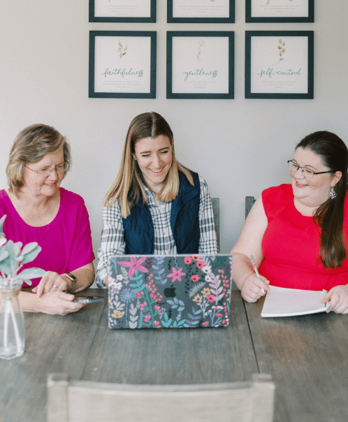 A few ladies looking at a computer screen together