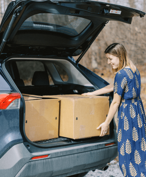 Tasha putting clutter in her car's trunk