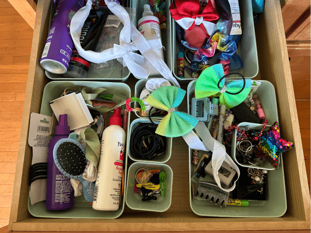 A messy drawer with items thrown in