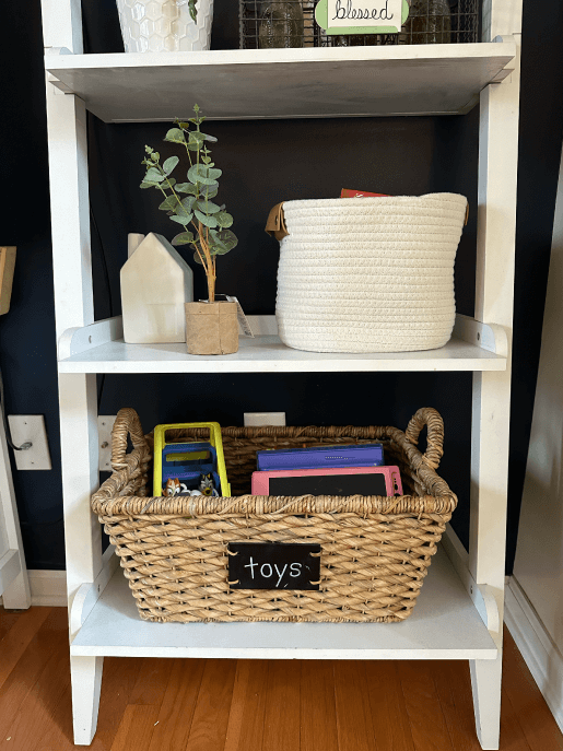 A basket of toys neatly tucked in a shelf